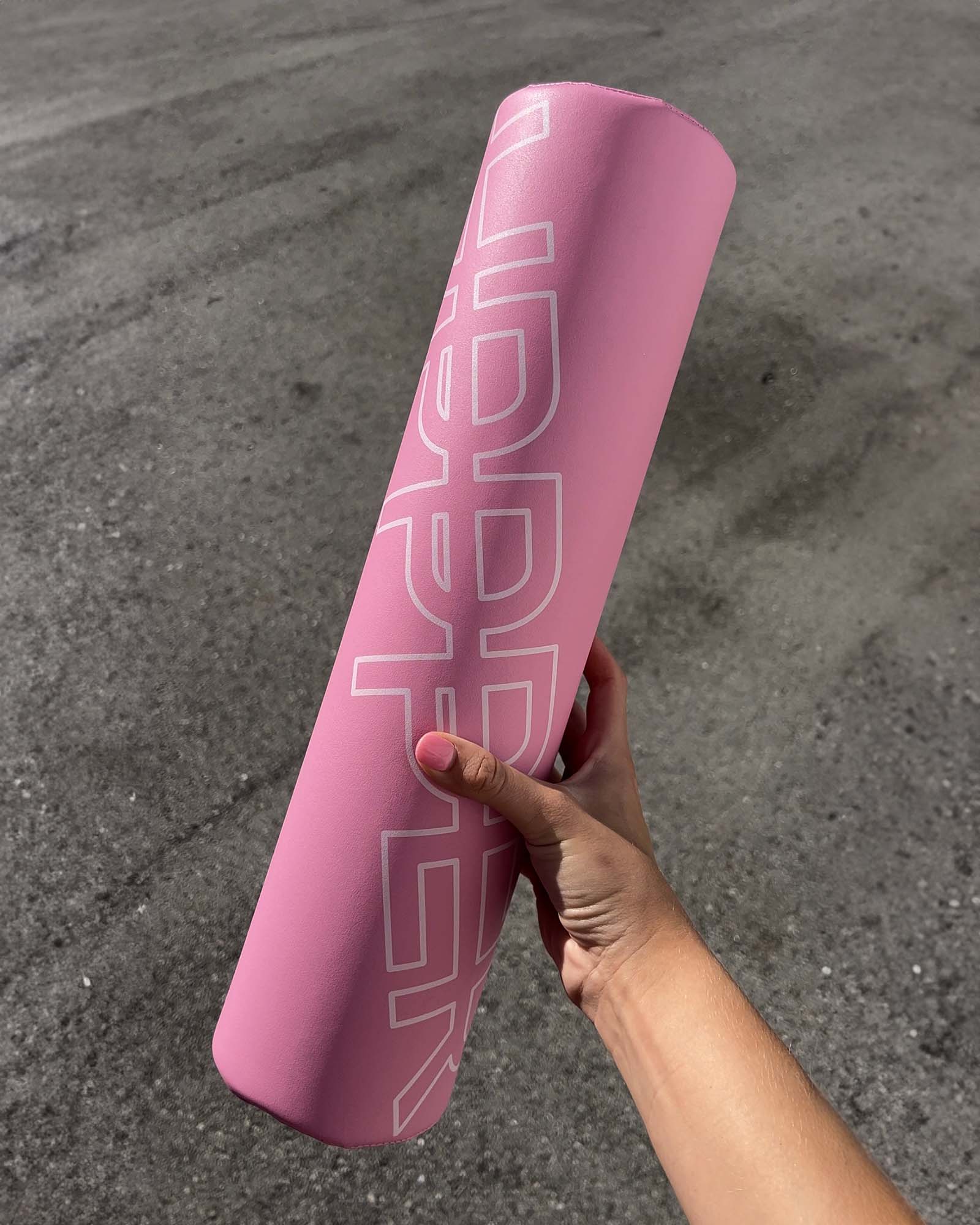 woman holding pink barbell pad