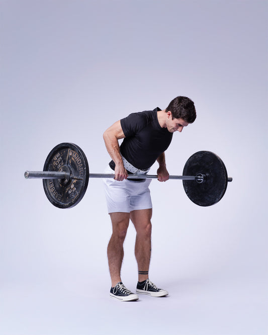man doing barbell rows with uppper lifting straps