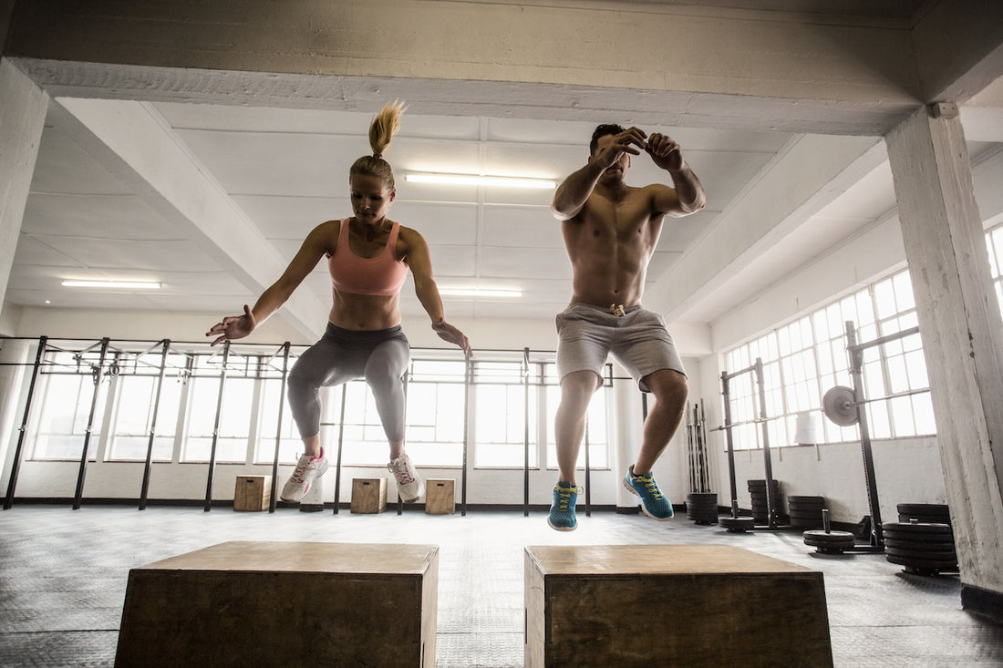 woman and man jumping on box