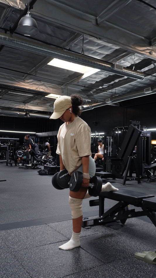 woman doing dumbbell leg exercise