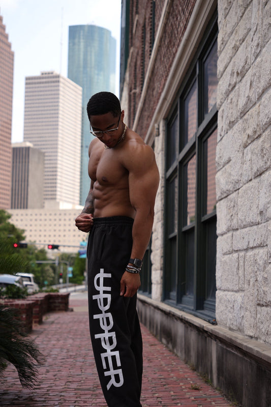 man flexing wearing uppper sweatpants
