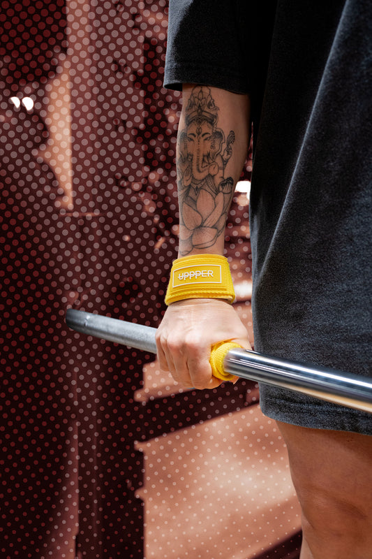 woman using weight lifting straps with barbell