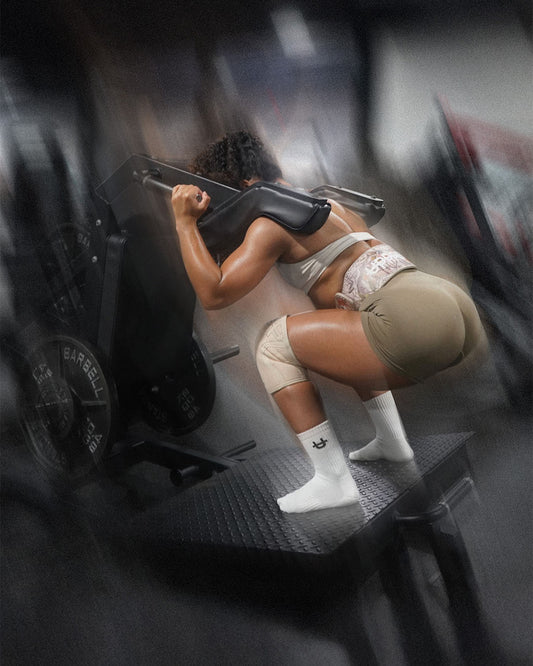 woman using a leg machine at the gym 