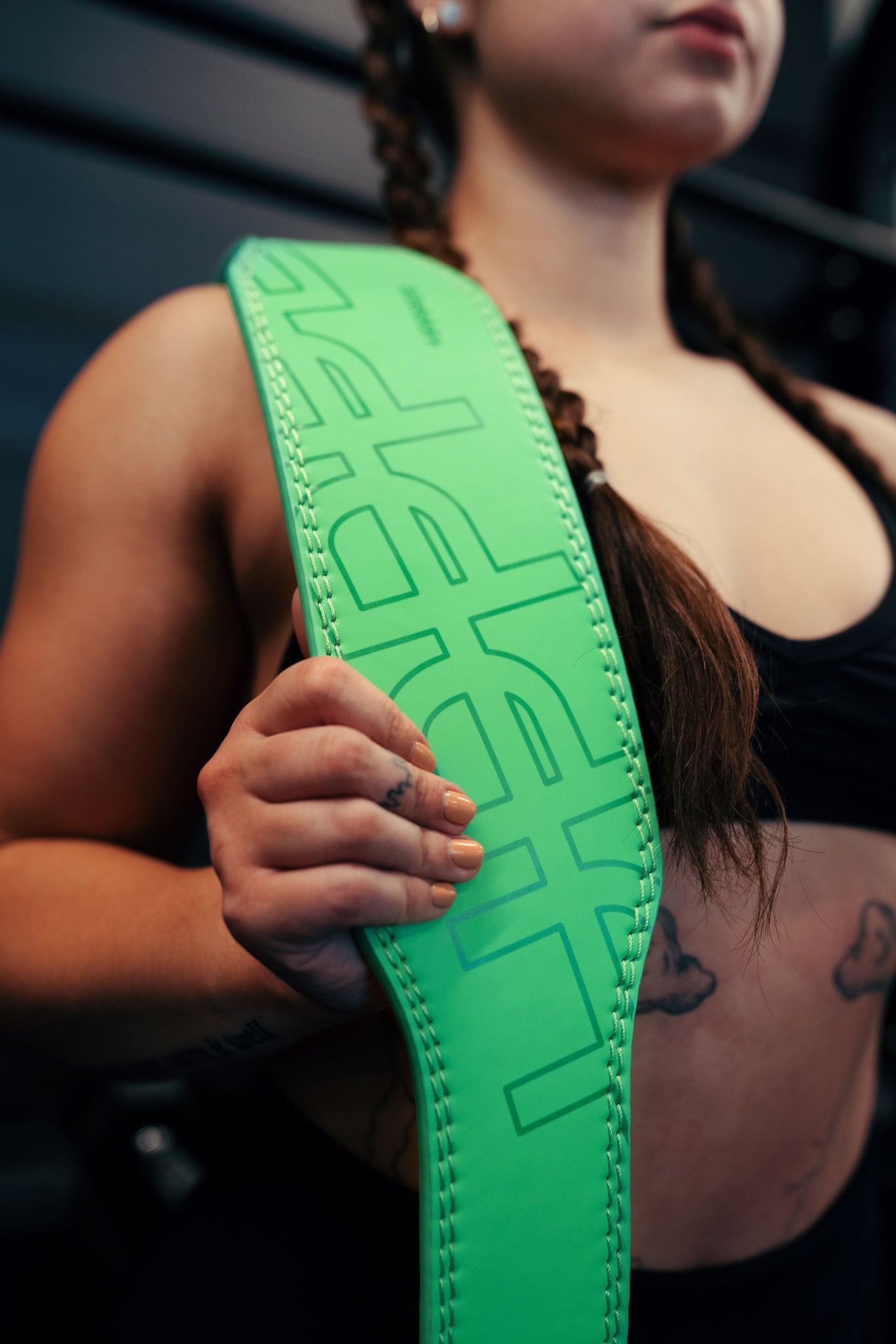 woman putting on a weightlifting belt