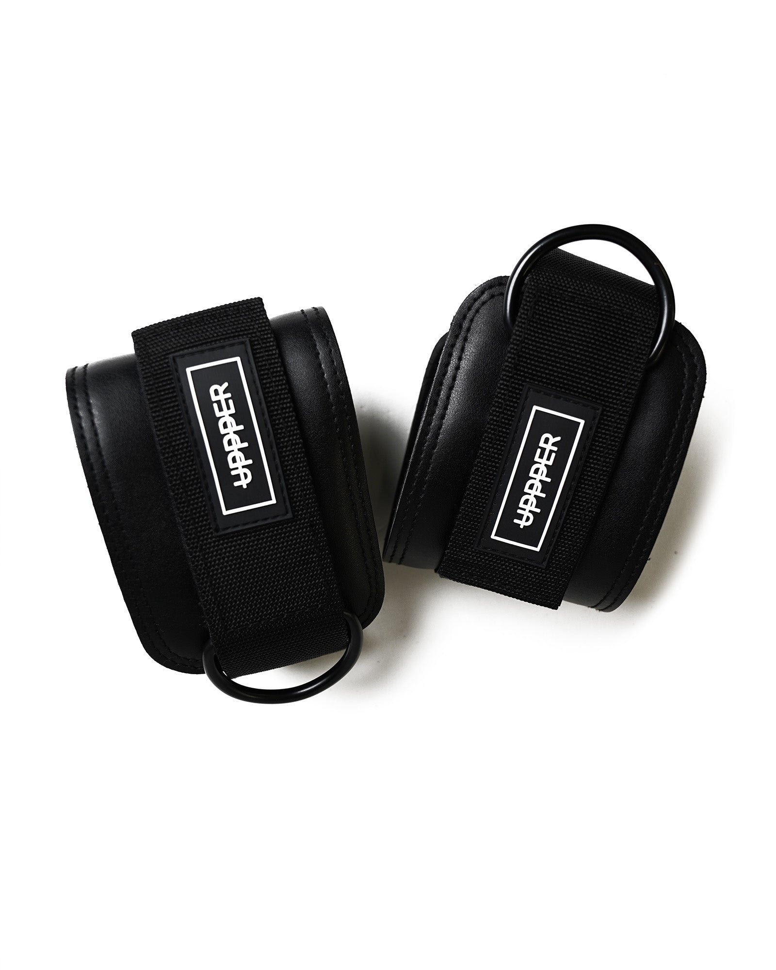 pair of black uppper ankle straps with d-rings and velcro closure on white background