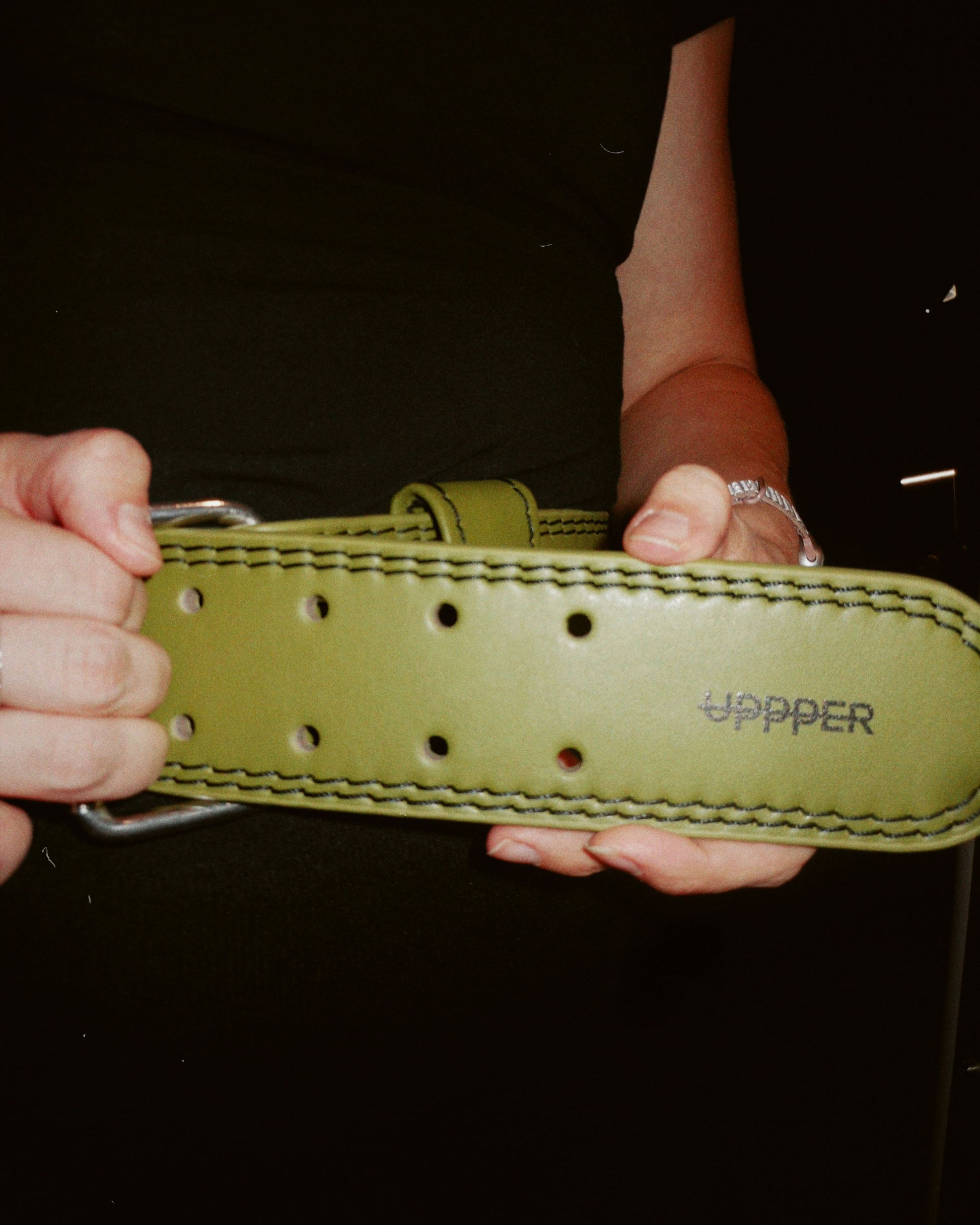 close-up of uppper khaki lifting belt showing small logo - lifestyle shot