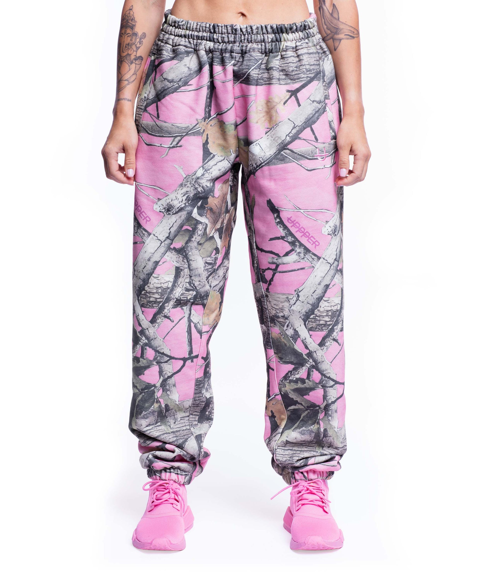 model wearing pink camo uppper sweatpants womens showing full leg on white background