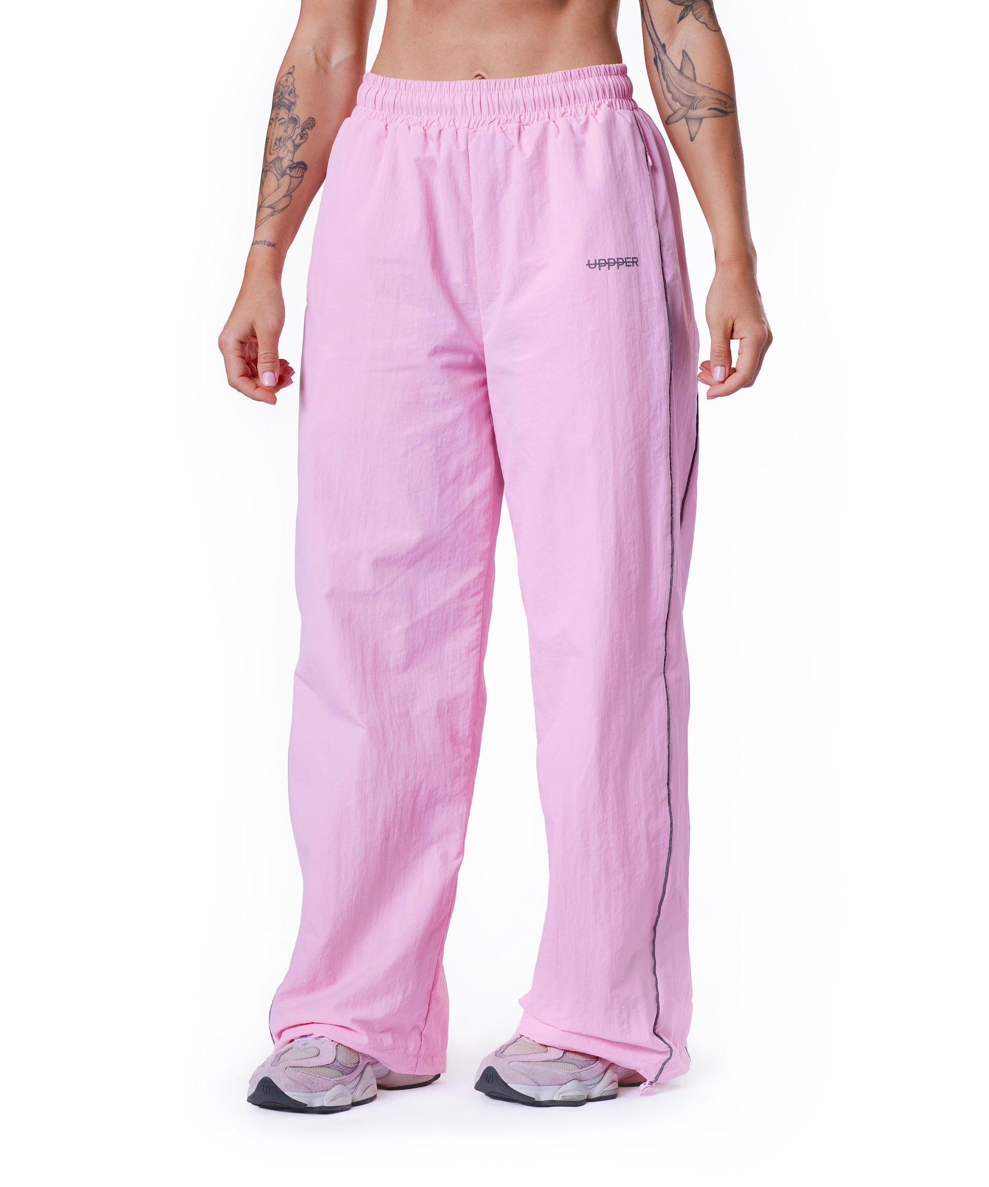 pink uppper track pants showing reflective lines on white background
