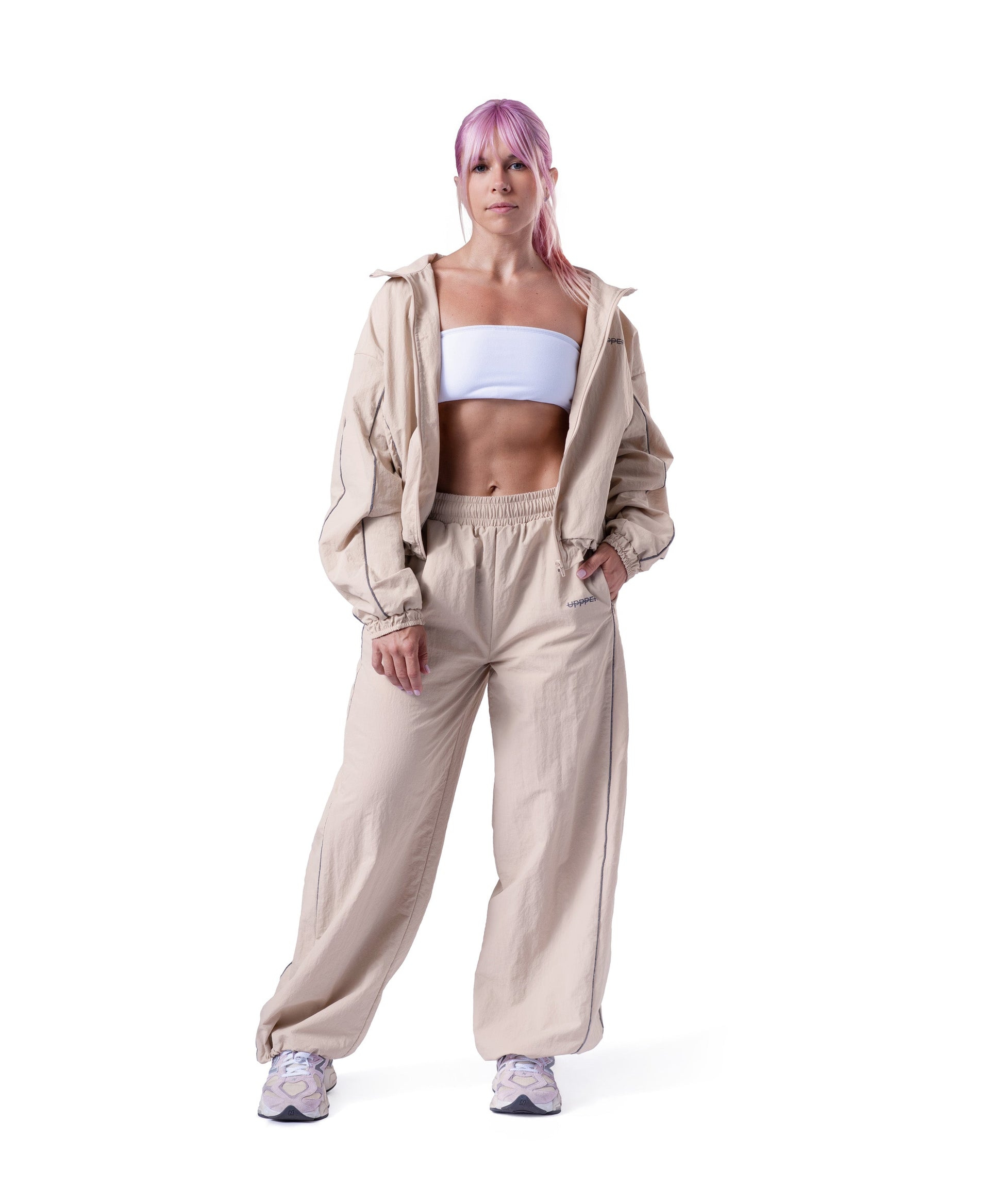 model wearing tan uppper track suit lifestyle shot